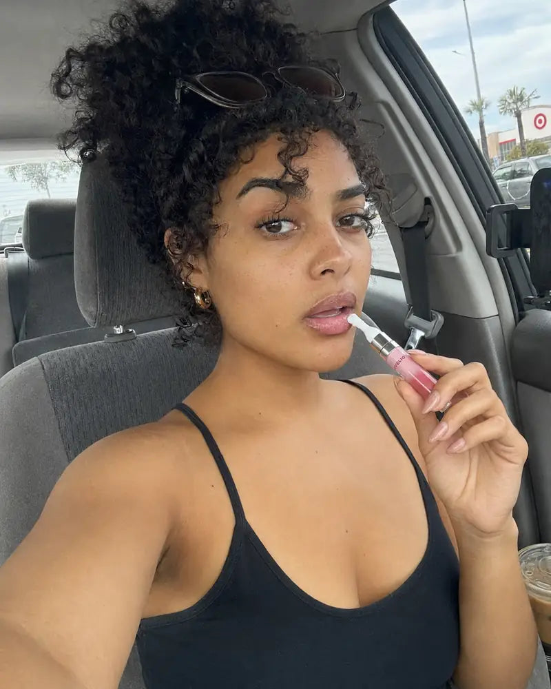 Daniela from Los Angeles applying Forever Pink Lip Essence in her car